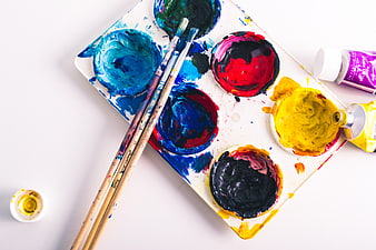 Colorful Paint Palette with Brushes and Tubes on White Background