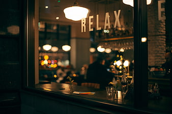 Night view of a cozy bar interior with relax sign