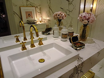Luxury bathroom vanity with gold faucets and marble countertop