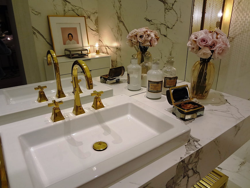 Luxury bathroom vanity with gold faucets and marble countertop