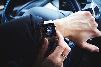 Smartwatch Displaying Electric Car Battery Status in Vehicle