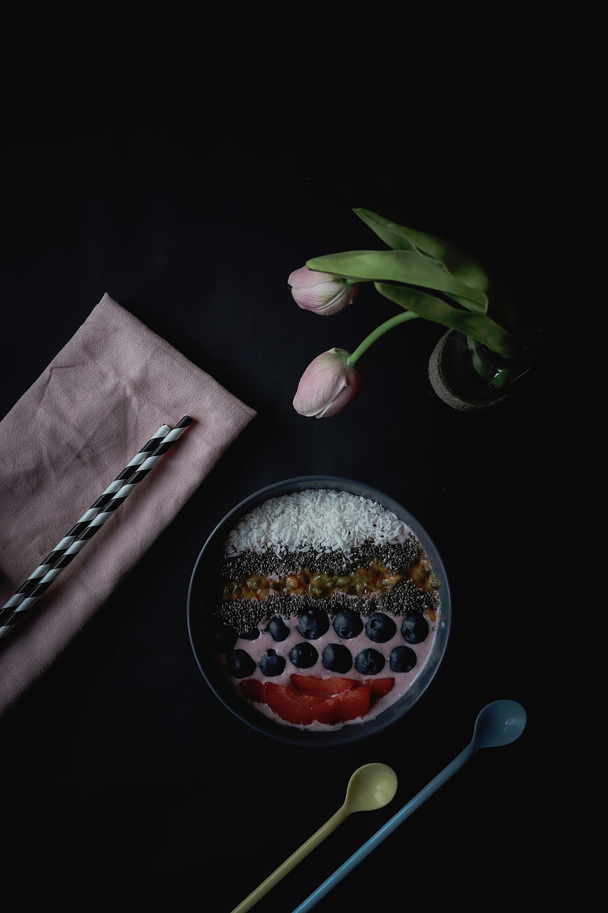 Overhead view of healthy acai bowl with berries and coconut