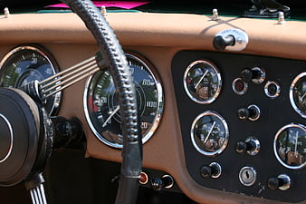 Vintage Car Dashboard with Gauges and Steering Wheel