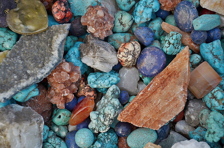 Colorful assortment of raw crystals, turquoise, and polished gemstones
