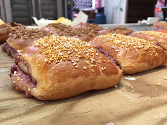 Freshly baked sweet bread rolls with crumb topping on wooden table