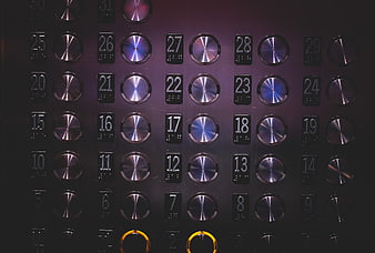 Close-up of elevator control panel with metallic buttons