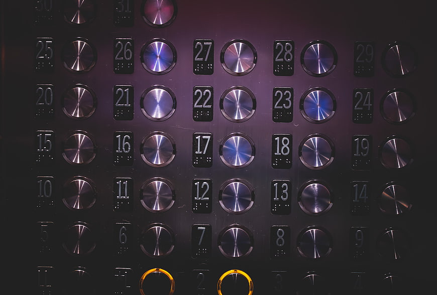 Close-up of elevator control panel with metallic buttons