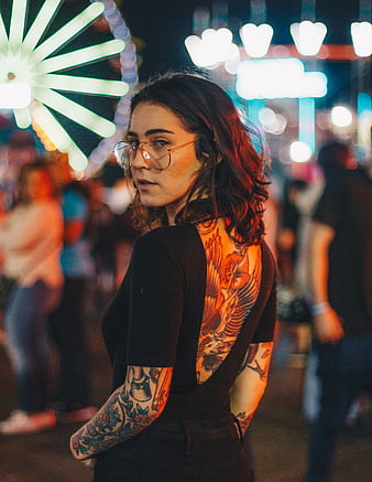 Woman with Back Tattoo at Night Carnival