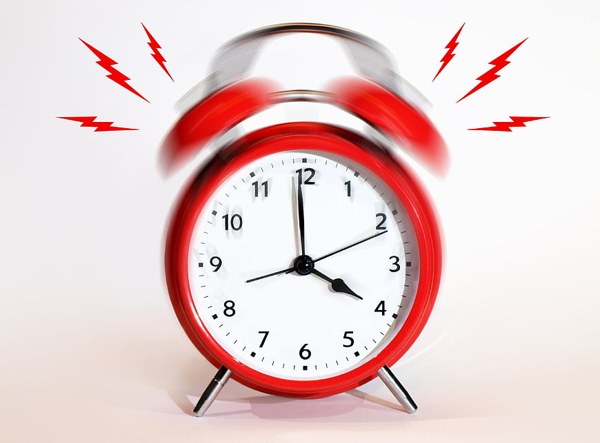 Red Alarm Clock Ringing with Motion Blur and Lightning Bolts