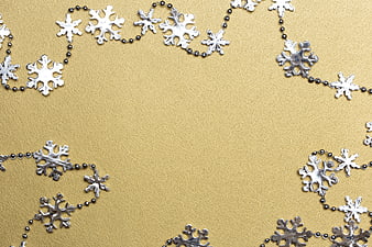 Silver Snowflake Garland on Gold Textured Background