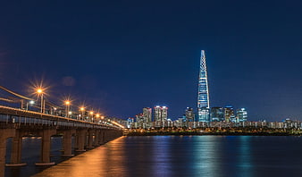 Seoul Cityscape at Night with Lotte World Tower and Han River Bridge