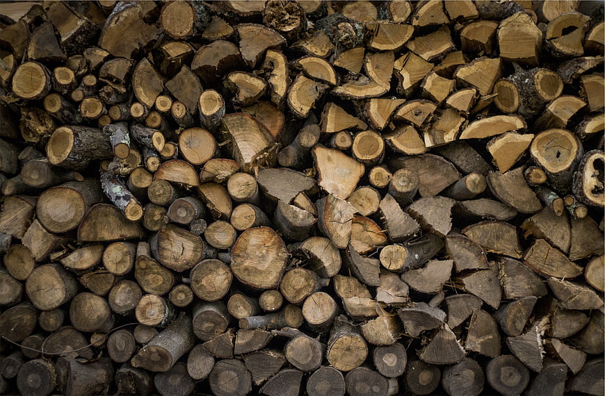 Stacked firewood logs texture background