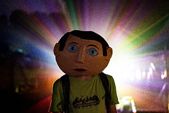 Person in Giant Paper Mask with Colorful Light Rays