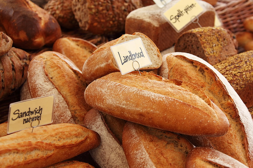 Assortment of fresh artisan bread loaves in bakery display