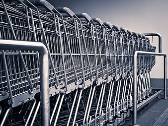 Row of nested metal shopping carts in a supermarket