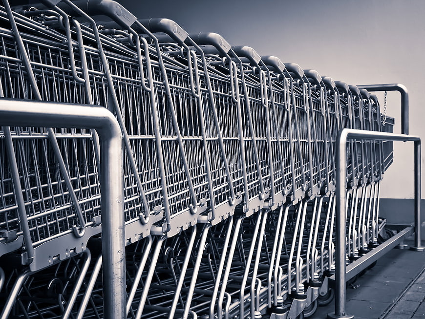 Row of nested metal shopping carts in a supermarket