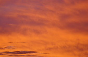 Vibrant Orange and Purple Sunset Sky with Clouds