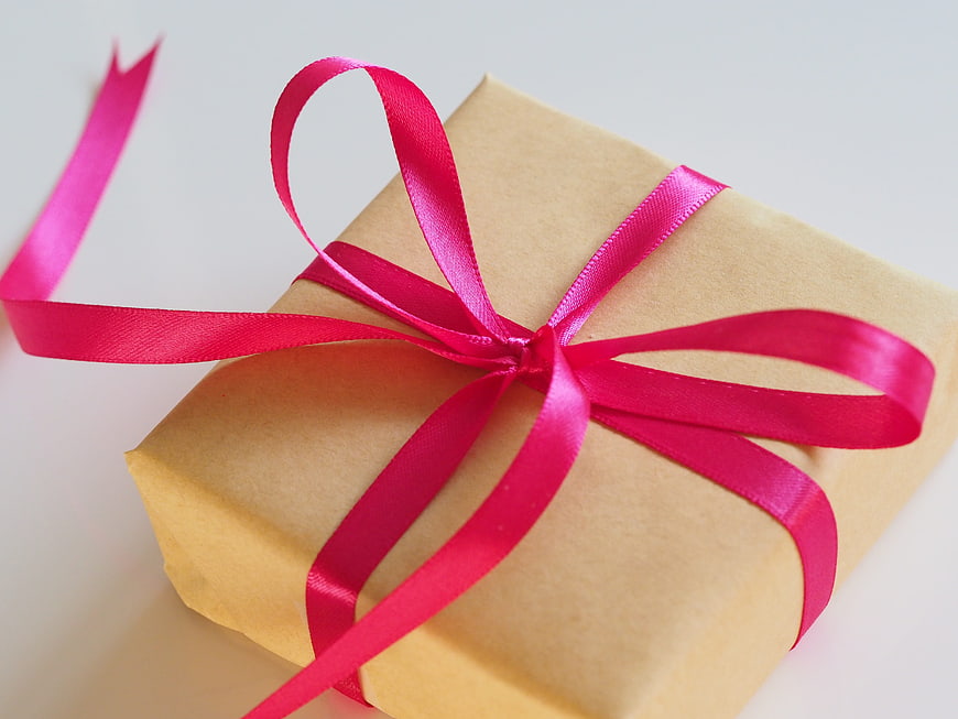 Gift Box Wrapped in Brown Paper with Pink Ribbon