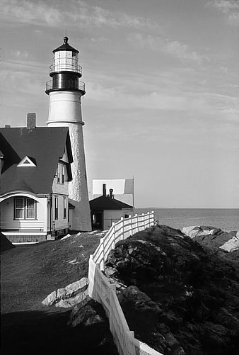 Black and White Lighthouse on Rocky Coastline