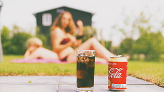 Coca-Cola Vanilla Can and Glass on Patio with Blurred People