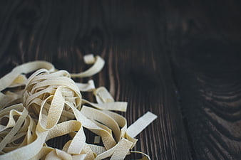 Fresh Tagliatelle Pasta on Dark Wooden Background