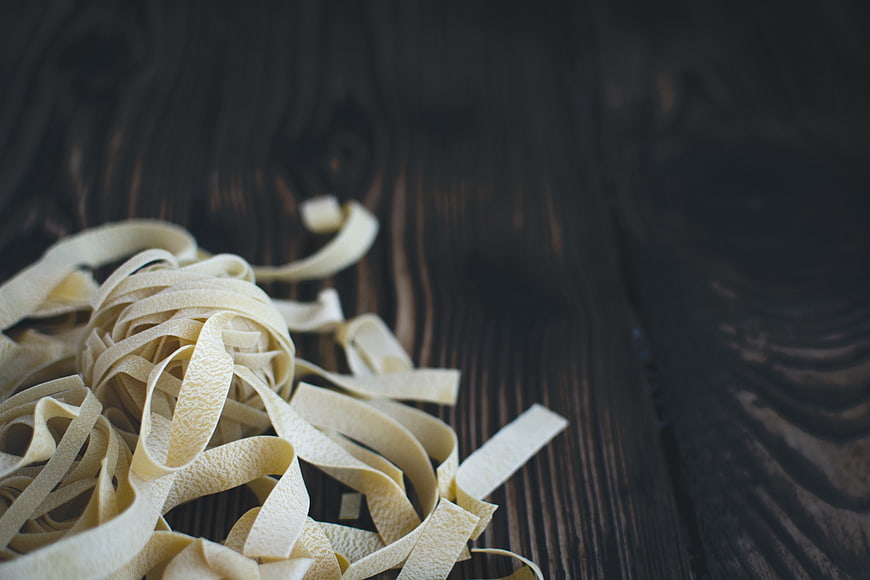 Fresh Tagliatelle Pasta on Dark Wooden Background