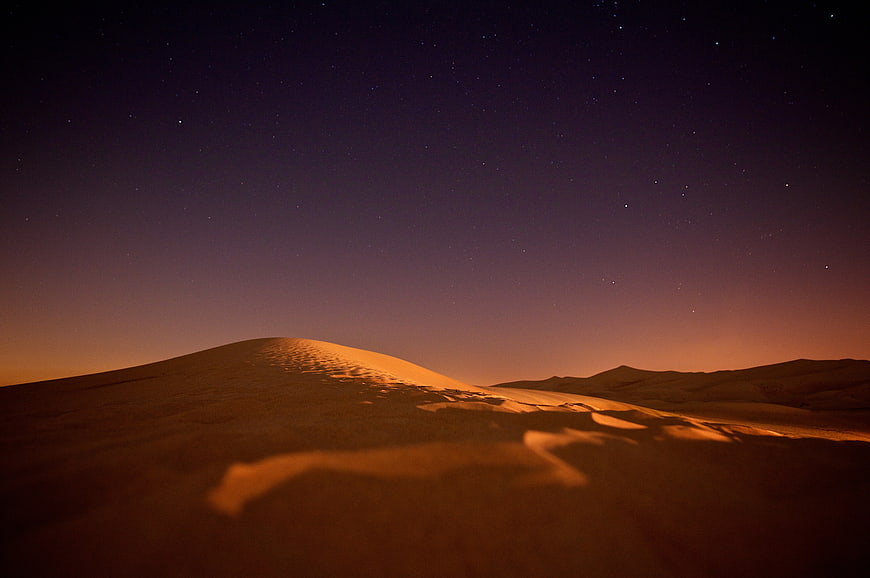 Starry Night Sky Over Golden Desert Dunes