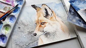 Watercolor fox painting on paper with art supplies and brushes