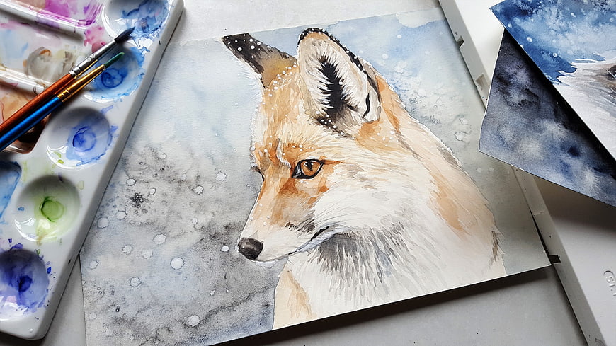 Watercolor fox painting on paper with art supplies and brushes