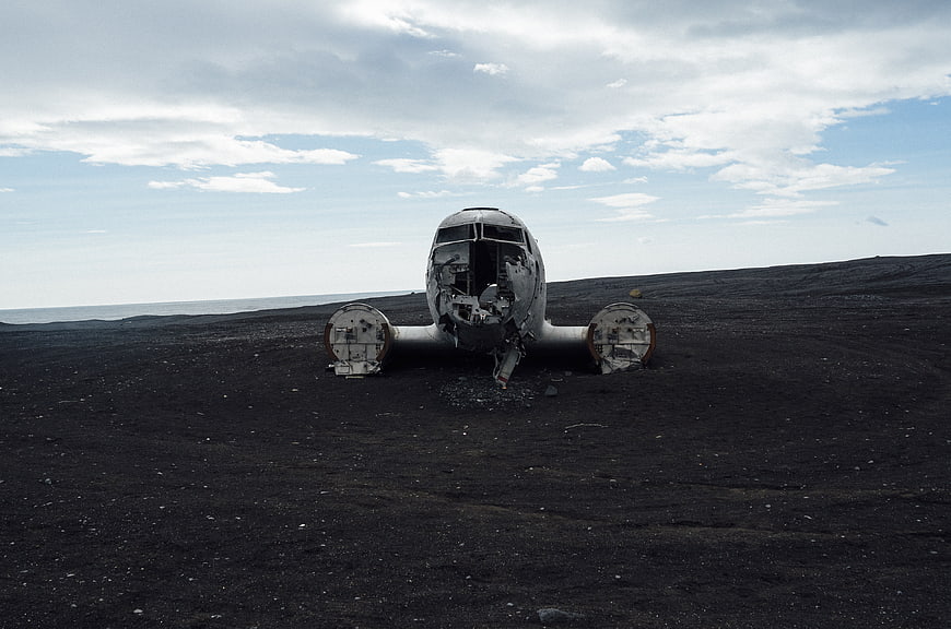 Crashed airplane wreck on black sand beach in Iceland