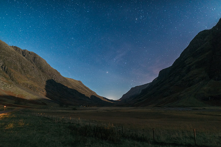 Starry Night Sky Over Mountain Valley Landscape