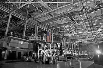 Black and white industrial factory interior with American flag