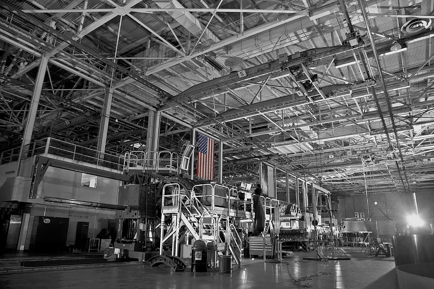 Black and white industrial factory interior with American flag