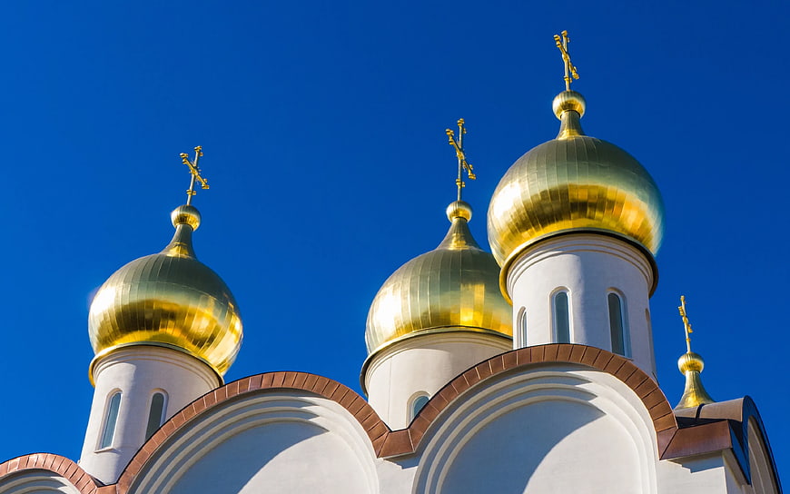Golden Orthodox Church Domes Against Blue Sky