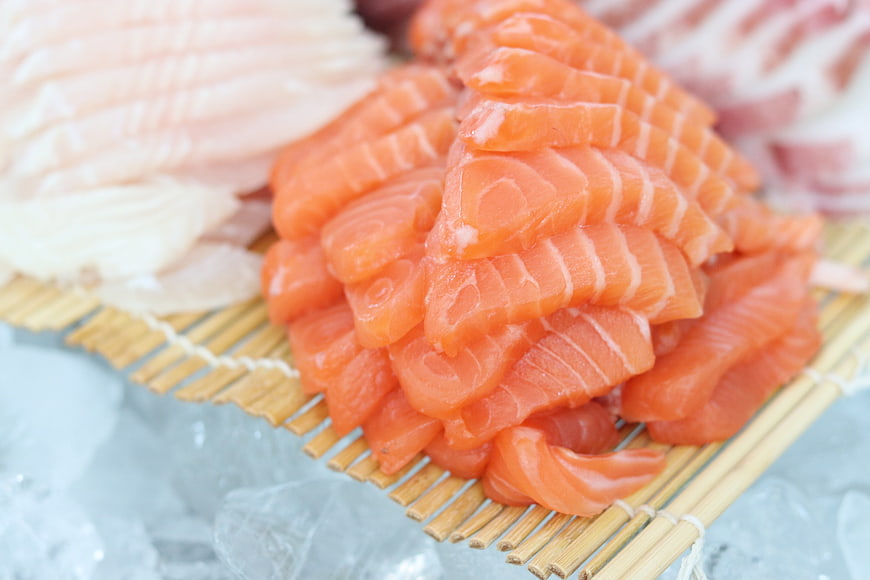 Fresh Salmon Sashimi Slices on Bamboo Mat with Ice