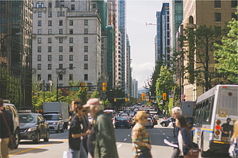 Busy Downtown City Street with Pedestrians and Traffic