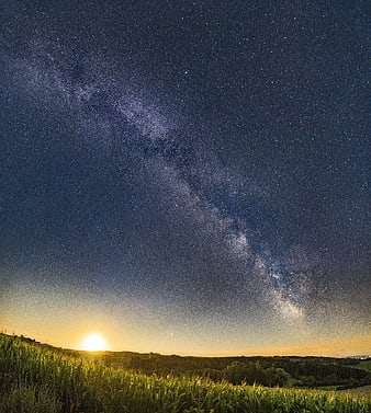 Milky Way Galaxy and Moonrise Over Green Countryside Landscape
