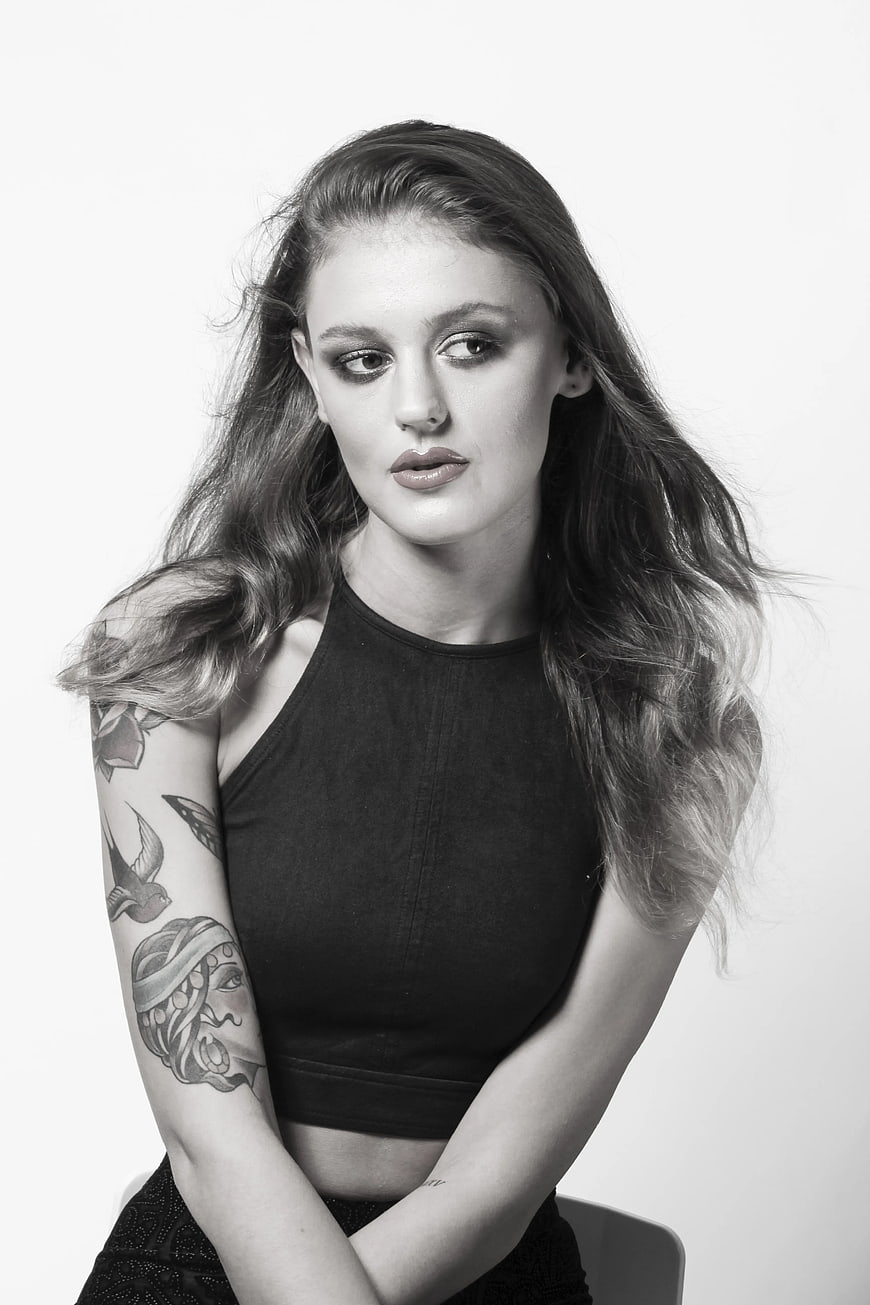 Black and white portrait of woman with tattoos