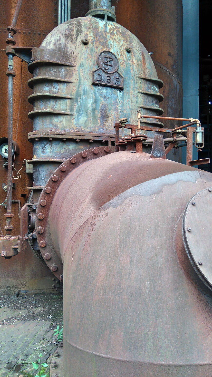 Rusty industrial machinery and pipes in an abandoned steel mill