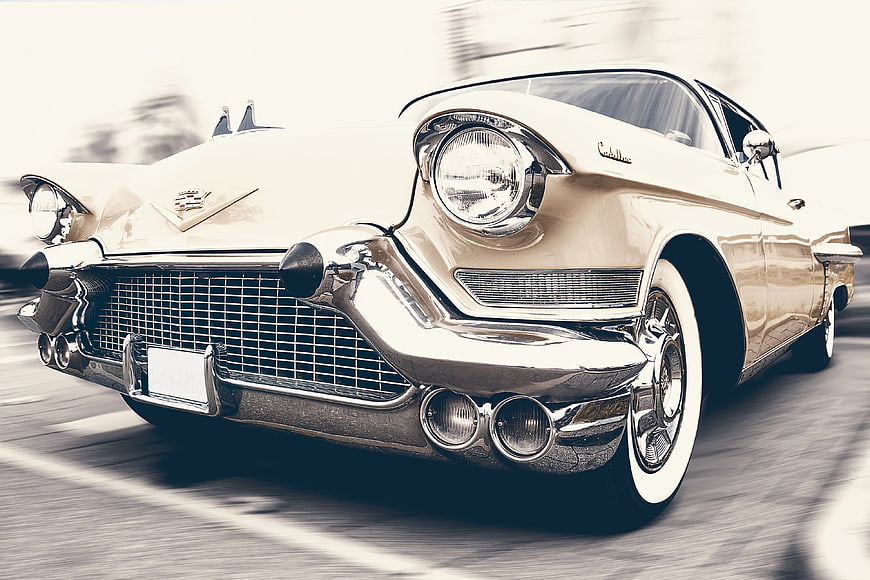 Vintage White Cadillac Eldorado Driving on Road