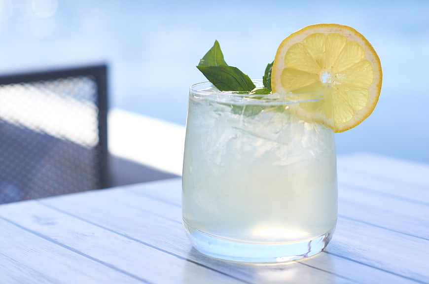 Refreshing Lemon Cocktail with Mint on White Table