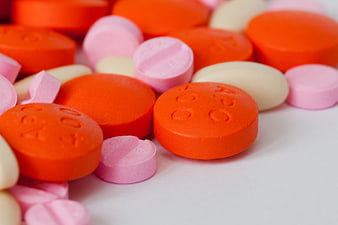 Close-up of colorful orange, pink, and white pharmaceutical pills