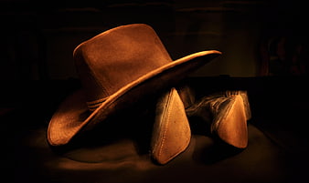 Vintage Cowboy Hat and Boots in Dramatic Warm Lighting