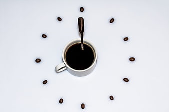 Top view coffee cup clock with beans on white background