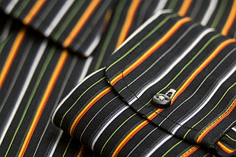 Close-up of striped shirt cuff with button detail