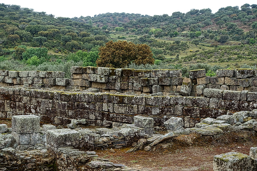 Ancient stone ruins with mossy walls and green hills