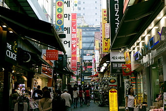 Busy Korean Shopping Street with Neon Signs and Crowds