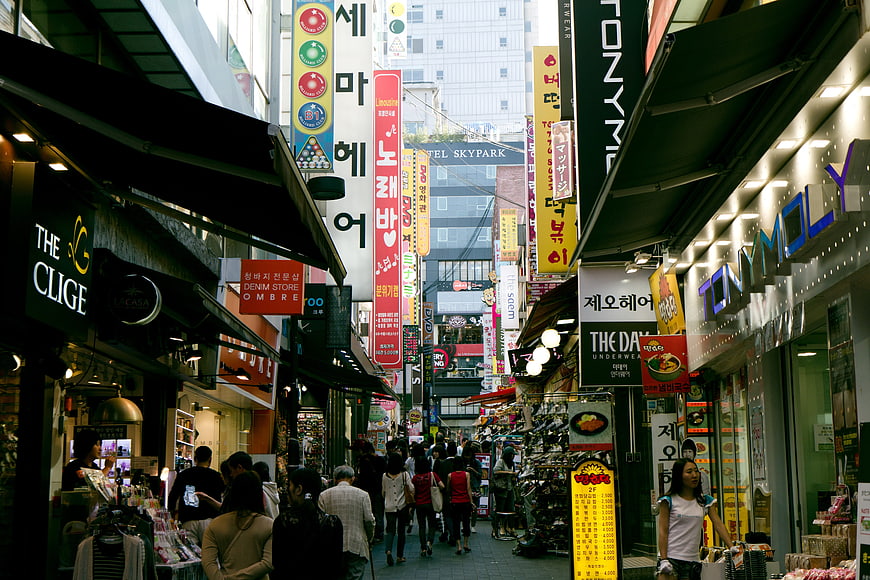 Busy Korean Shopping Street with Neon Signs and Crowds