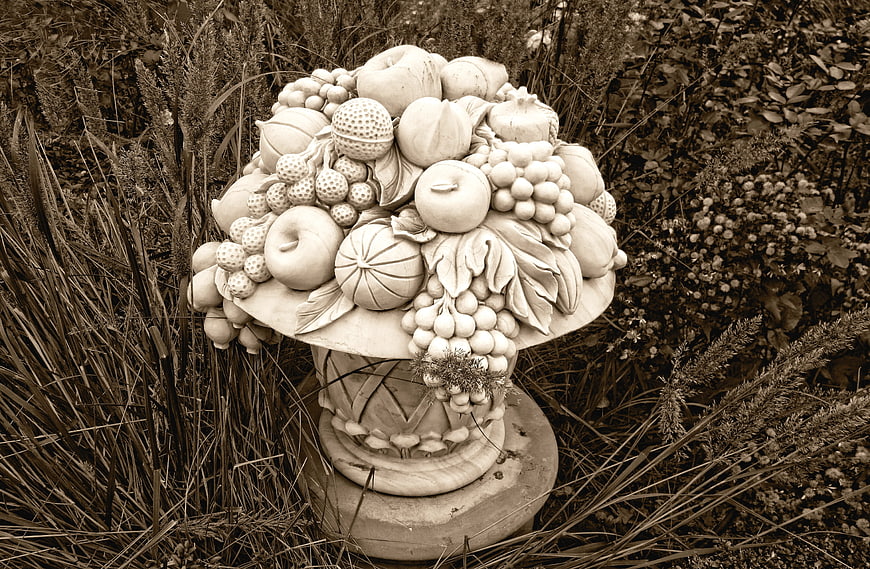 Sepia-toned stone fruit basket garden ornament