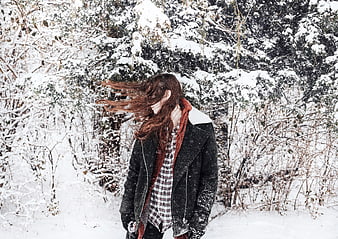 Woman with Windblown Hair in Snowy Winter Forest